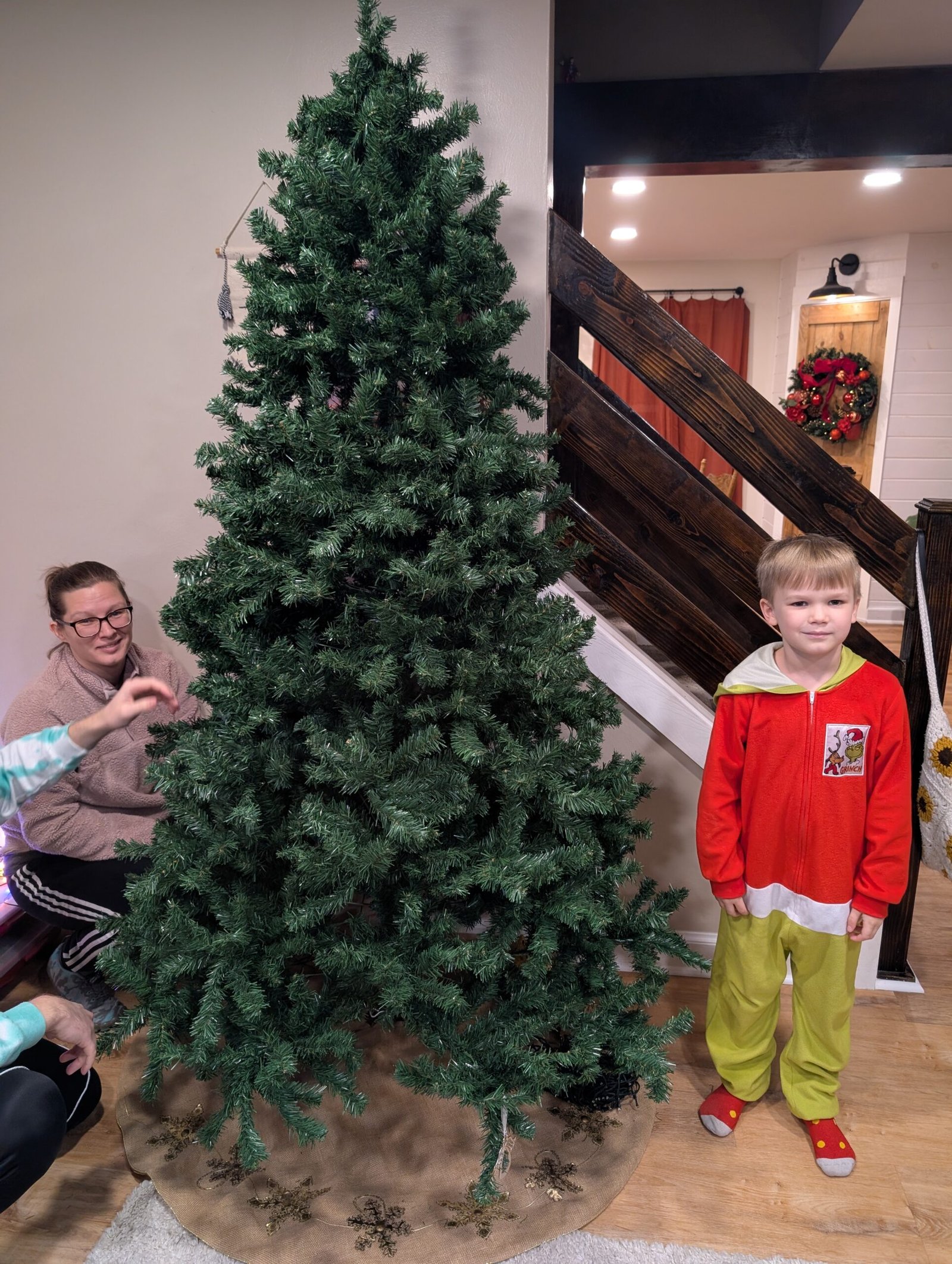 Unboxing Memories: How Our Christmas Tree Became a Timeline of Grace, Growth, and God's Faithfulness Our bare Christmas tree freshly set up in the living room, ready for memories to be hung.