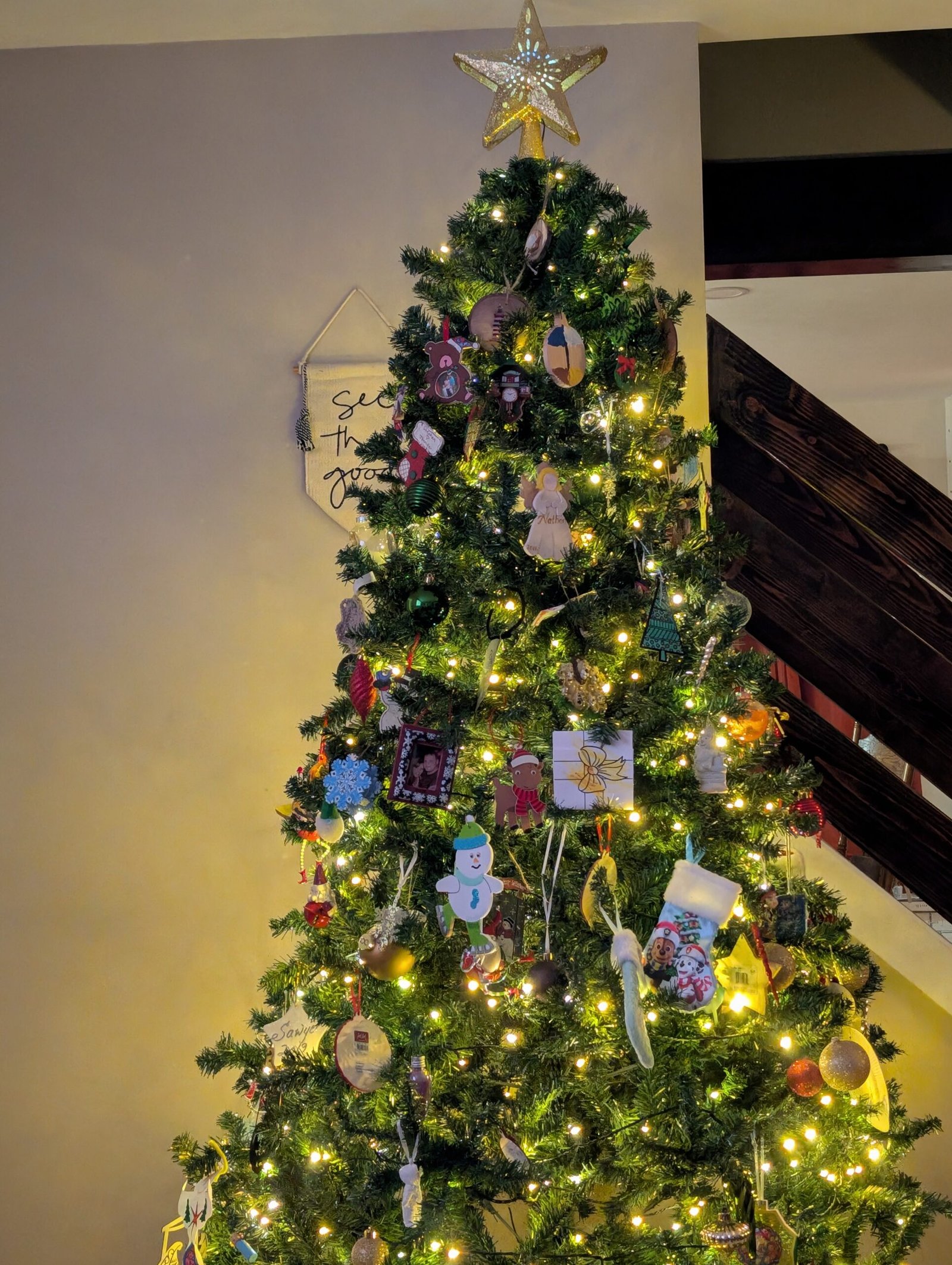 Unboxing Memories: How Our Christmas Tree Became a Timeline of Grace, Growth, and God's Faithfulness The fully decorated Christmas tree, aglow with lights and ornaments, complete with family touches.