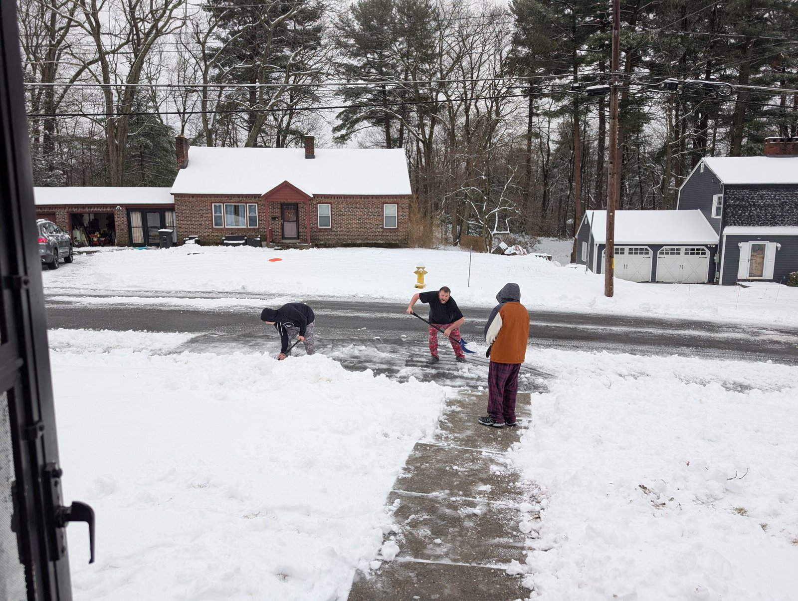 Shoveling Snow and Building Bonds: A Winter Lesson in Simple Family Time Our boys and husband finishing up shoveling the driveway, covered in snow but smiling big